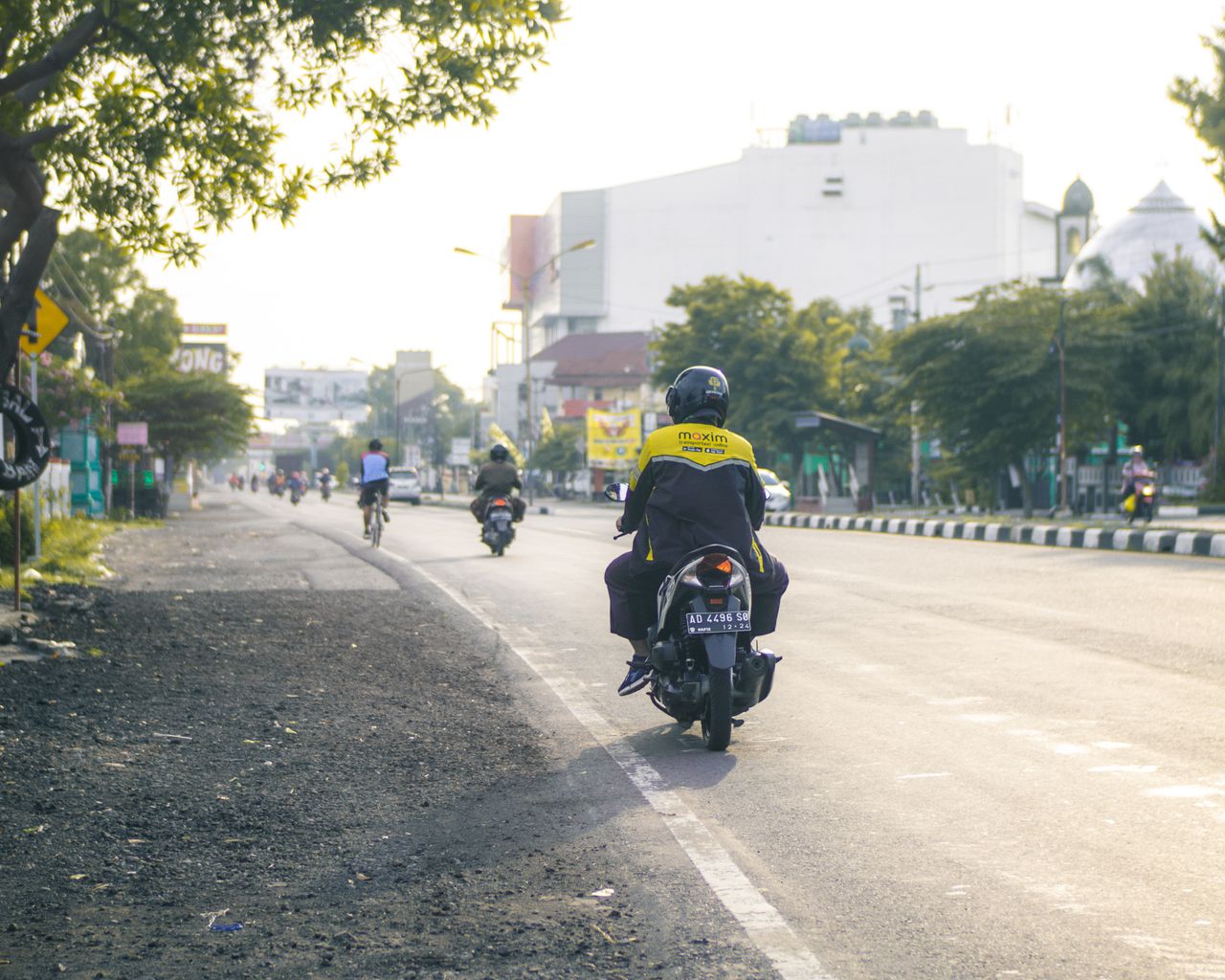 The Art of Drawing Readers In: Your attractive post title goes here Motorcycle delivery rider navigating through a busy city street during the day.